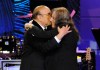 FILE - Music producer Clive Davis, left, and recording artist Patti Smith embrace onstage at the Clive Davis Pre-Grammy Gala in Beverly Hills, Calif., on Feb. 9, 2013. (Photo by Chris Pizzello/Invision/AP, File)