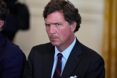 FILE - Tucker Carlson attends a meeting with President Donald Trump and oil executives in the East Room of the White House, Jan. 9, 2026, in Washington. (AP Photo/Alex Brandon, File)