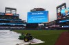 A sign announcing the postponement of a baseball game between the New York Mets and Chicago Cubs due to weather is shown on the field, Monday, June 22, 2026, in New York. (AP Photo/Heather Khalifa)