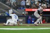 Toronto Blue Jays' Andres Gimenez (0) scores a run ahead of a tag by Houston Astros catcher Yainer Diaz off a fly-out by Vladimir Guerrero Jr. during fourth inning MLB baseball action in Toronto, Monday, June 22, 2026. THE CANADIAN PRESS/Jon Blacker