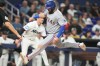 Texas Rangers' Jake Burger scores on a sacrifice fly hit by Elias Díaz during the eighth inning of a baseball game against the Miami Marlins, Monday, June 22, 2026, in Miami. (AP Photo/Lynne Sladky)