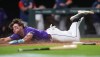 Colorado Rockies' Cole Carrigg dives into home plate to score the winning run on a three-run walkoff triple hit by Jake McCarthy off Boston Red Sox relief pitcher Aroldis Chapman in the ninth inning of a baseball game Monday, June 22, 2026, in Denver. (AP Photo/David Zalubowski)