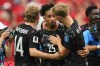 Canada's Nathan Saliba, center, becomes emotional and is consoled by Jacob Shaffelburg, left, and Luc de Fougerolles, right, after their team's win in the World Cup Group B soccer match against Qatar in Vancouver, British Columbia, Thursday, June 18, 2026. (AP Photo/Abbie Parr)