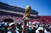 A fan holds up a replica of the World Cup trophy at a fan festival at the Los Angeles Memorial Coliseum in Los Angeles, Thursday, June 11, 2026, during a live broadcast of the World Cup soccer match between Mexico and South Africa. (AP Photo/Jae C. Hong)