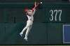 Philadelphia Phillies left fielder Edmundo Sosa cannot catch a double hit by Washington Nationals' Dylan Crews that bounces off the fence during the fifth inning of a baseball game, Monday, June 22, 2026, in Washington. (AP Photo/John McDonnell)