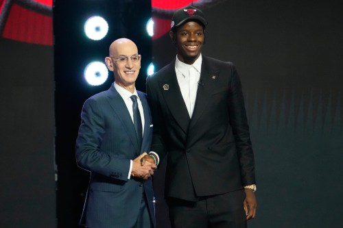 Caleb Wilson, right, poses for a photo with NBA Commissioner Adam Silver, left, after being selected by the Chicago Bulls in the first round of the NBA basketball draft, Tuesday, June 23, 2026, in New York. (AP Photo/Yuki Iwamura)