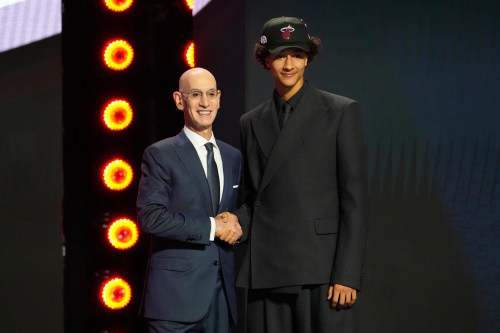 Nate Ament greets NBA Commissioner Adam Silver, left, after being selected by the Milwaukee Bucks as the 13th pick in the first round of the NBA basketball draft, Tuesday, June 23, 2026, in New York. (AP Photo/Yuki Iwamura)