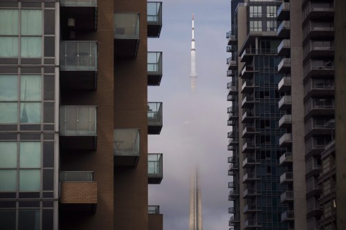 The CN Tower can be seen behind condo's in Toronto's Liberty Village community in Toronto, Ontario on Tuesday, April 25, 2017. THE CANADIAN PRESS/Cole Burston