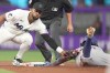 Texas Rangers Nicky Lopez (33) gets tagged out by Miami Marlins shortstop Otto Lopez (6) in the third inning of a baseball game, Wednesday, June 24, 2026, in Miami. (AP Photo/Jim Rassol)