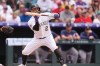 Colorado Rockies' Tyler Freeman puts down a bunt to drive in a run from third base against Boston Red Sox relief pitcher Justin Slaten in the eighth inning of a baseball game Wednesday, June 24, 2026, in Denver. (AP Photo/David Zalubowski)