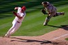 Los Angeles Angels' Nolan Schanuel, left, scores on a walk-off single by Logan O'Hoppe as Baltimore Orioles catcher Samuel Basallo is unable to tag him during the 10th inning of a baseball game Wednesday, June 24, 2026, in Anaheim, Calif. (AP Photo/Mark J. Terrill)
