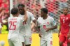 Canada's Promise David (24) celebrates with teammates Nathan Saliba (25) and Jonathan David (10) during the World Cup Group B soccer match between Switzerland and Canada in Vancouver, British Columbia, Wednesday, June 24, 2026. (AP Photo/Abbie Parr)