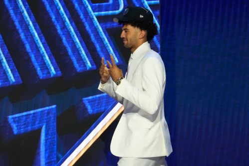 Cameron Boozer gestures as he walks off the stage after being chosen by the Memphis Grizzlies in the first round of the NBA basketball draft, Tuesday, June 23, 2026, in New York. (AP Photo/Yuki Iwamura)