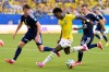 Brazil's Vinicius Junior (7) battles for the ball with with Scotland's Nathan Patterson (22) and Lewis Ferguson (19) during the World Cup Group C soccer match between Scotland and Brazil in Miami Gardens, Fla., Wednesday, June 24, 2026. (AP Photo/Rebecca Blackwell)