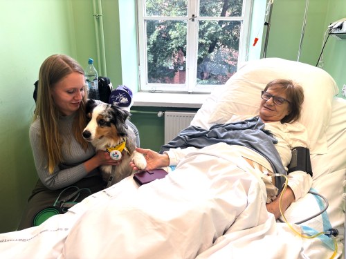 Medical student Malgorzata Brzozowska and her therapy dog Kluska visit the bedside of patient Ewa Lutka-Krawczyk at the Palliative Medicine Clinic at the Medical University of Warsaw, Poland, Monday, June 15, 2026. (AP Photo/Vanessa Gera)