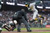 Umpire Ramon de Jesus, middle, watches as San Francisco Giants catcher Eric Haase, bottom, reaches to tag out Athletics' Jacob Wilson, top, during the fifth inning of a baseball game Wednesday, June 24, 2026, in San Francisco. (AP Photo/Jeff Chiu)