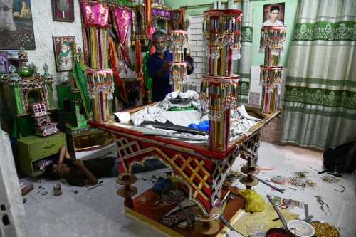 Raju Rathore, an artisan from Pakistani Hindu community, makes a replica of the mausoleum of Imam Hussain locally called 'Tazia', in preparation for the upcoming Ashoura, when Shiites Muslims mark the death of Hussein, at his home in Karachi, Pakistan, Tuesday, June 23, 2026. (AP Photo/Ali Raza)