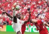 Canada's Promise David (24) takes a shot on goal as Switzerland's Granit Xhaka (10) defends during the second half of a World Cup Group B soccer match, in Vancouver, on Wednesday, June 24, 2026. THE CANADIAN PRESS/Darryl Dyck