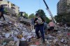 Residents search through the rubble of a building that collapsed in an earthquake in Caracas, Venezuela, Thursday, June 25, 2026. (AP Photo/Ariana Cubillos)