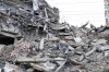 A man walks among the rubble of a building that collapsed in earthquakes the previous day in La Guaira, Venezuela, Thursday, June 25, 2026. (AP Photo/Pedro Mattey)