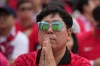 A soccer fan react as he watches a live broadcasting of the World Cup Group A soccer match between South Africa and South Korea at a public viewing venue in Seoul, South Korea, Thursday, June 25, 2026. (AP Photo/Lee Jin-man)