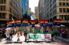 FILE - Marchers with the Greater Seattle Business Association, Washington State's LGBTQ+ and allied chamber of commerce, hold rainbow letters spelling out 