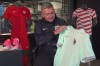 Phil McCartney, chief innovation, design and product officer for Nike, holds up the away jersey for France that the company designed for the World Cup during an interview at Nike headquarters in Beaverton, Ore., on June 22, 2026. (AP Photo/Claire Rush)