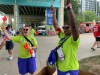 Volunteers Nicole Johnston, left, and Mbalu Lumor, right, wave 
