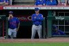 New York Mets manager Carlos Mendoza center, looks out from the dugout during the fourth inning of a baseball game against the Cincinnati Reds in Cincinnati, Monday, June 15, 2026. (AP Photo/Carolyn Kaster)