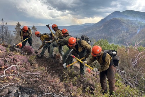 This undated image provided by the U.S. Forest Service Friday, June 26, 2026, shows firefighters responding to the Cottonwood Fire on Wednesday, June 24, 2026, above Birch Lake, near Beaver, Utah. (Mike McMillan/U.S. Forest Service via AP)