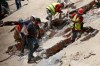 Rescue workers search through the rubble of a collapsed building two days after earthquakes struck Caracas, Venezuela, on Friday, June 26, 2026. (AP Photo/Pedro Mattey)