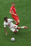 Canada's Jonathan David (10) cries out as he falls in front of Switzerland's Michel Aebischer (20) during the World Cup Group B soccer match between Switzerland and Canada in Vancouver, British Columbia, Wednesday, June 24, 2026. (AP Photo/Kaleb Tatum)