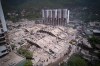 Residents and rescue workers search through the rubble two days after an earthquake struck La Guaira, Venezuela, Friday, June 26, 2026. (AP Photo/Juan Pablo Arraez)