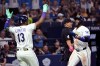 Tampa Bay Rays' Junior Caminero (13) and Yandy Díaz celebrate after Diaz scores on a double by Jonathan Aranda, not pictured, during the seventh inning of a baseball game against the Arizona Diamondbacks Friday, June 26, 2026, in St. Petersburg, Fla. (AP Photo/Jason Behnken)