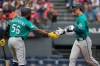 Seattle Mariners' Colt Emerson, right, is congratulated by Randy Arozarena (56) after hitting a home run in the third inning of a baseball game against the Cleveland Guardians in Cleveland, Friday, June 26, 2026. (AP Photo/Sue Ogrocki)
