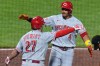 Cincinnati Reds' Noelvi Marte (4) celebrates with Sal Stewart (27) as he crosses home plate after hitting a two-run home run off Pittsburgh Pirates pitcher Mason Montgomery during the eighth inning of a baseball game in Pittsburgh, Friday, June 26, 2026. (AP Photo/Gene J. Puskar)