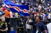 Cape Verde head coach Bubista waves the flag as he celebrates with fans after their 0-0 draw against Saudi Arabia after the World Cup Group H soccer match in Houston, Friday, June 26, 2026. (AP Photo/David J. Phillip)