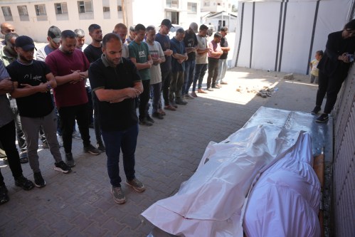 Mourners pray over the bodies of Palestinian men who were killed in an Israeli airstrike in the Maghazi refugee camp on Friday, during their funeral in Deir al-Balah, Gaza Strip, Saturday, June 27, 2026. (AP Photo/Abdel Kareem Hana)