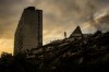 A man stand atop a mountain of rubble three days after twin earthquakes struck, in La Guaira, Venezuela, Saturday, June 27, 2026. (AP Photo/Matias Delacroix)