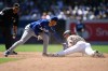 San Diego Padres' Jackson Merrill (3) steals second base ahead of the tag of Los Angeles Dodgers shortstop Mookie Betts (50) during the sixth inning of a baseball game, Sunday, June 28, 2026, in San Diego. (AP Photo/Denis Poroy)