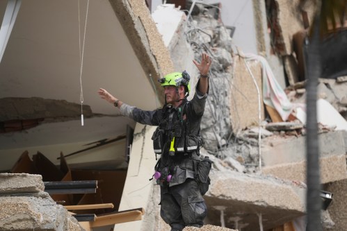 A rescuer from a U.S. search-and-rescue team evaluates access to an earthquake-damaged building in Catia La Mar, Venezuela, Sunday, June 28, 2026. (AP Photo/Fernando Vergara)