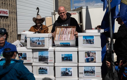 Mitch Sylvestre hold boxes of signatures before submitting signatures for a separation referendum to Elections Alberta in Edmonton, on Monday, May 4, 2026. THE CANADIAN PRESS/Jason Franson