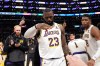FILE - Los Angeles Lakers forward LeBron James salutes public address announcer Lawrence Tanter prior to an NBA basketball game against the Denver Nuggets Saturday, March 2, 2024, in Los Angeles. (AP Photo/Mark J. Terrill,File)