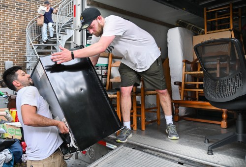 Sasha Dobroruka, right, and Carlos Barrera load a mini-refrigerator onto a truck in Montreal on Quebec’s unofficial “Moving Day,” Tuesday, July 1, 2025. THE CANADIAN PRESS/Graham Hughes