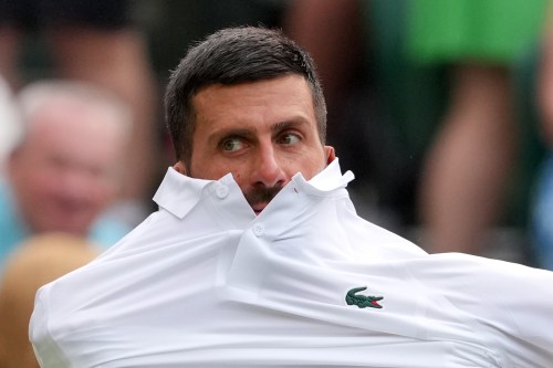 Novak Djokovic of Serbia changes his shirt during the men's singles match against Yibing Wu of China at the Wimbledon Tennis Championships in London, Monday, June 29, 2026.(AP Photo/Kin Cheung)