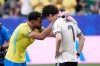 Brazil's Matheus Cunha (9) consoles Japan's Ao Tanaka (7) at the end of the World Cup round of 32 soccer match between Brazil and Japan in Houston, Monday, June 29, 2026. (AP Photo/David J. Phillip)
