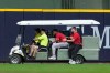 Cincinnati Reds' Dane Myers, center, is carted off the field after suffering an injury during the fourth inning of a baseball game against the Milwaukee Brewers, Monday, June 29, 2026, in Milwaukee. (AP Photo/Aaron Gash)