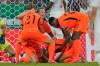 Netherlands' Cody Gakpo, kneeling, is congratulated by teammates after scoring his team's first goal during the World Cup round of 32 soccer match between the Netherlands and Morocco in Guadalupe, near Monterrey, Mexico, Monday, June 29, 2026. (AP Photo/Ricardo Mazalan)