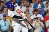 Chicago Cubs' Seiya Suzuki of Japan, hits a sacrifice fly to San Diego Padres center fielder Jackson Merrill during the fifth inning of a baseball game in Chicago, Monday, June 29, 2026. (AP Photo/Nam Y. Huh)