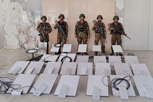 FILE - In this image provided by the Myanmar military on Oct. 19, 2025, soldiers stand next to Starlink satellite internet devices from the KK Park scam compound in Myawaddy township, Karen State, Myanmar. (The Myanmar Military True News Information Team via AP, File)